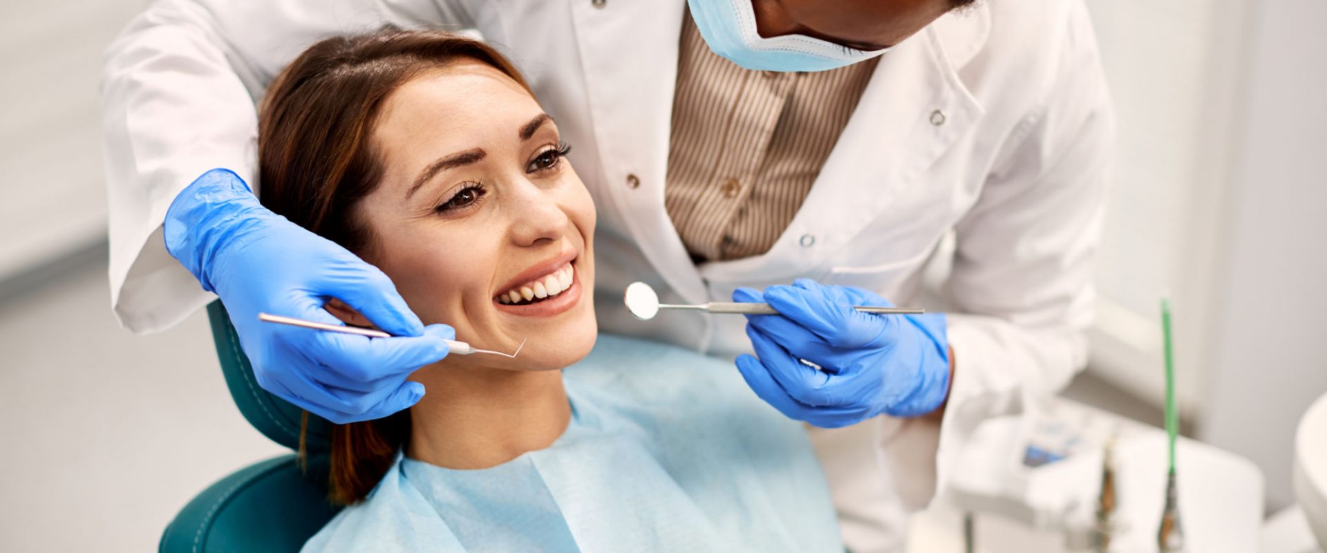 Happy woman having her teeth checked during appointment at dental clinic.