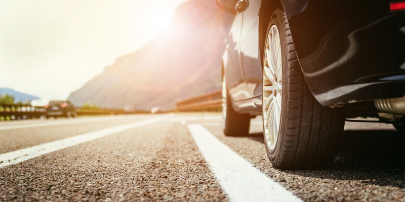 Close up of a car standing on a breakdown lane, summer vacation