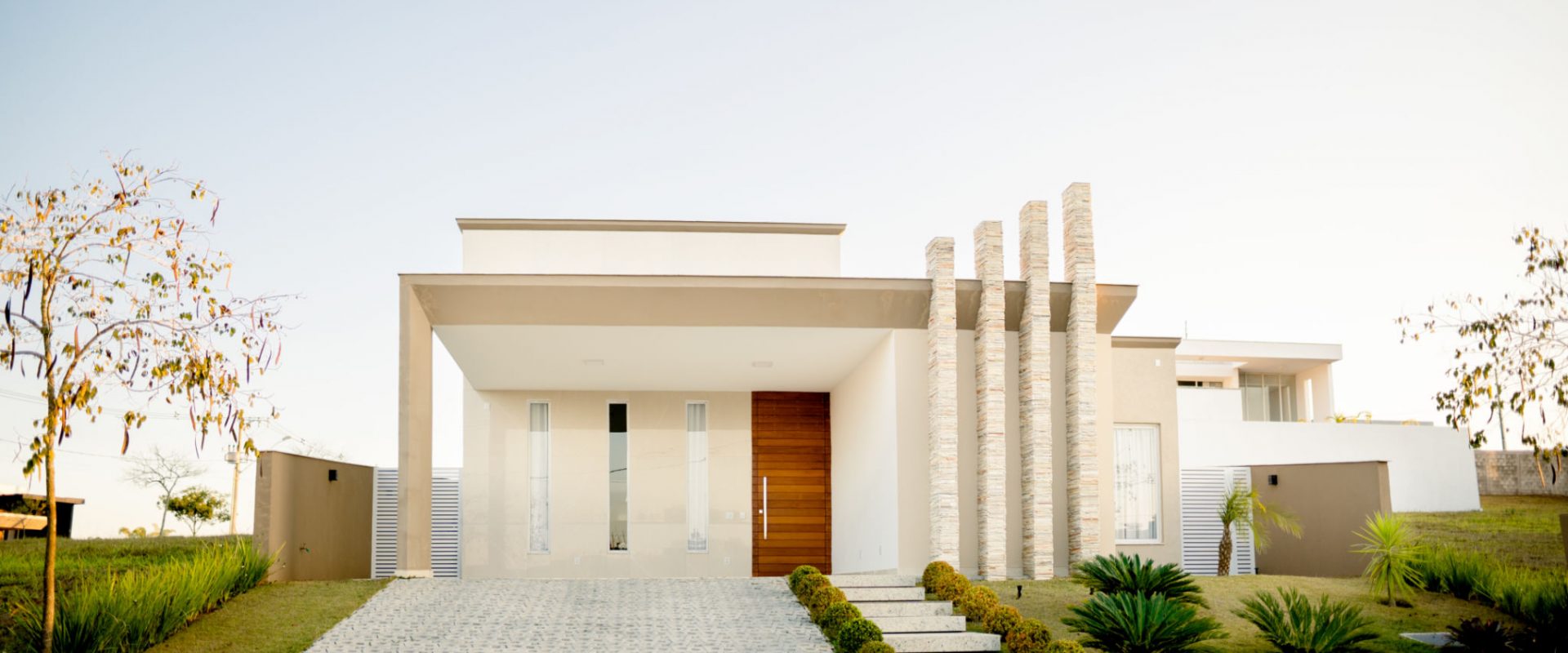 Stylish facade of a modern home with contemporary architectural features on a late afternoon in the summertime